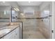 Modern bathroom with granite vanity and a large walk-in shower at 19807 Bridgetown Loop, Venice, FL 34293