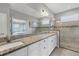 Large bathroom with granite countertops and a walk-in shower at 19807 Bridgetown Loop, Venice, FL 34293