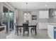 Kitchen dining area with table and chairs, adjacent to sliding doors at 19807 Bridgetown Loop, Venice, FL 34293