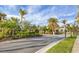 Gated community entrance with palm trees and lush landscaping at 19807 Bridgetown Loop, Venice, FL 34293