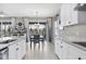 Kitchen with white cabinets, granite countertops and eat-in area at 19807 Bridgetown Loop, Venice, FL 34293