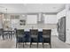 Bright kitchen with white cabinets, granite counters and an island at 19807 Bridgetown Loop, Venice, FL 34293