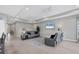 Spacious living room with gray couches and tile floors at 19807 Bridgetown Loop, Venice, FL 34293