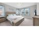 Spacious main bedroom with a large bed and plenty of natural light at 19807 Bridgetown Loop, Venice, FL 34293