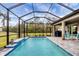 Relaxing pool and patio with screened enclosure, outdoor grill and seating at 19807 Bridgetown Loop, Venice, FL 34293