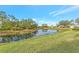 Peaceful canal-front view with lush landscaping at 200 Silver Lake Dr # 105, Venice, FL 34292