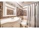 Clean bathroom with marble-look walls and white vanity at 2066 Sunset Point Rd # 91, Clearwater, FL 33765