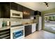 Modern kitchen with dark cabinets and granite countertops at 2066 Sunset Point Rd # 91, Clearwater, FL 33765