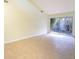 Bright living room, tile floors, access to patio at 2066 Sunset Point Rd # 91, Clearwater, FL 33765