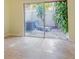 Private patio with seating and lush tropical plants at 2066 Sunset Point Rd # 91, Clearwater, FL 33765