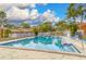 Community pool with lounge chairs and surrounding landscaping at 2066 Sunset Point Rd # 91, Clearwater, FL 33765