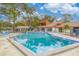 Community pool with lounge chairs and surrounding landscaping at 2066 Sunset Point Rd # 91, Clearwater, FL 33765