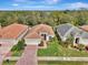 Attractive home with tile roof, driveway, and lush landscaping at 2136 Mesic Hammock Way, Venice, FL 34292