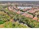Aerial of community, showcasing homes and lake at 2136 Mesic Hammock Way, Venice, FL 34292