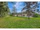 Spacious backyard, screened pool, and green grass at 2136 Mesic Hammock Way, Venice, FL 34292