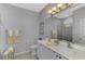 Elegant bathroom with double vanity, large mirror, and plenty of counter space at 2136 Mesic Hammock Way, Venice, FL 34292