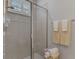 Clean bathroom with a walk-in shower, tiled walls, and a window for natural light at 2136 Mesic Hammock Way, Venice, FL 34292