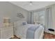 Cozy bedroom with a queen bed, window with plantation shutters, and a ceiling fan at 2136 Mesic Hammock Way, Venice, FL 34292