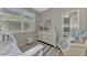 Bedroom with white dresser and comfortable seating area at 2136 Mesic Hammock Way, Venice, FL 34292