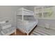 bedroom with a white bunk bed and window seat at 2136 Mesic Hammock Way, Venice, FL 34292