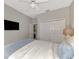 Bright bedroom with a comfortable bed, large closet, and TV at 2136 Mesic Hammock Way, Venice, FL 34292