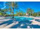 Relaxing community pool with palm trees and lounge chairs at 2136 Mesic Hammock Way, Venice, FL 34292
