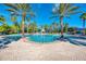 Large community pool surrounded by palm trees at 2136 Mesic Hammock Way, Venice, FL 34292