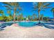Resort-style pool with palm trees and a covered patio at 2136 Mesic Hammock Way, Venice, FL 34292