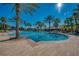 Inviting community pool with palm trees and a clubhouse at 2136 Mesic Hammock Way, Venice, FL 34292