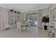 Elegant dining room with a round table and access to the pool area at 2136 Mesic Hammock Way, Venice, FL 34292