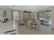 Charming dining room with round table and access to backyard patio at 2136 Mesic Hammock Way, Venice, FL 34292