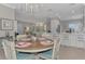 Well-lit dining room with round table and kitchen views at 2136 Mesic Hammock Way, Venice, FL 34292