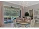 Charming dining room with round table and view of the kitchen at 2136 Mesic Hammock Way, Venice, FL 34292