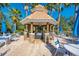 Community grilling station with tables and umbrellas at 2136 Mesic Hammock Way, Venice, FL 34292