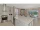 Open kitchen with large island, white cabinets, and views to the backyard at 2136 Mesic Hammock Way, Venice, FL 34292