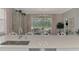 Bright kitchen features a large island with seating, stainless steel appliances, and views to the backyard at 2136 Mesic Hammock Way, Venice, FL 34292