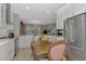 Bright kitchen with white cabinets, breakfast nook, and stainless steel appliances at 2136 Mesic Hammock Way, Venice, FL 34292