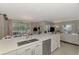 Modern kitchen boasts a large island, double sink, stainless steel appliances, and an open layout at 2136 Mesic Hammock Way, Venice, FL 34292