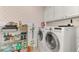 Laundry room with washer, dryer, and ample storage at 2136 Mesic Hammock Way, Venice, FL 34292