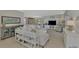 Open living area with comfortable seating, built-in shelving, and a light color palette at 2136 Mesic Hammock Way, Venice, FL 34292