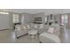 Open living room with a sectional sofa and view of the kitchen at 2136 Mesic Hammock Way, Venice, FL 34292