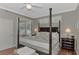 Bright main bedroom with a post bed, window seat, and private access to the backyard at 2136 Mesic Hammock Way, Venice, FL 34292