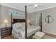 Spacious main bedroom with a post bed, ample natural light, and a ceiling fan at 2136 Mesic Hammock Way, Venice, FL 34292