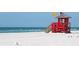 Beachfront view with lifeguard stand and ocean at 2280 Stickney Point Rd # 437, Sarasota, FL 34231