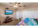 Small bedroom with twin bed and wooden desk at 2280 Stickney Point Rd # 437, Sarasota, FL 34231