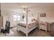 Spacious bedroom with a post bed, dresser, and ceiling fan at 2280 Stickney Point Rd # 437, Sarasota, FL 34231