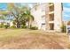 Two-story building with balconies, landscaping, and ample parking at 2280 Stickney Point Rd # 437, Sarasota, FL 34231