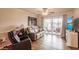 Comfortable living room with hardwood floors and balcony access at 2280 Stickney Point Rd # 437, Sarasota, FL 34231
