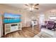 Bright living room with hardwood floors, large TV, and comfy seating at 2280 Stickney Point Rd # 437, Sarasota, FL 34231