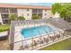 Community pool with a screened enclosure at 2280 Stickney Point Rd # 437, Sarasota, FL 34231